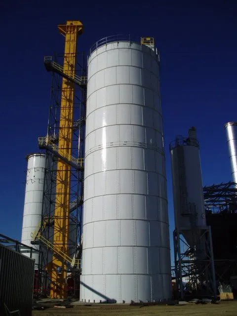 Mechanical bucket conveyor being installed on bulk storage silo.