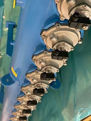 Row of new pulse valves on baghouse header