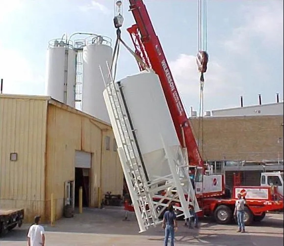 Crane installing a woodworking shop dust collection system