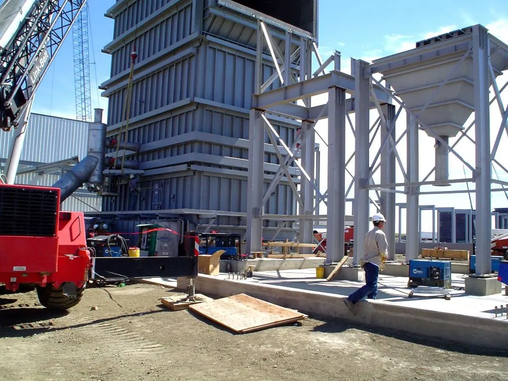 Structural supports being installed in concrete foundation.