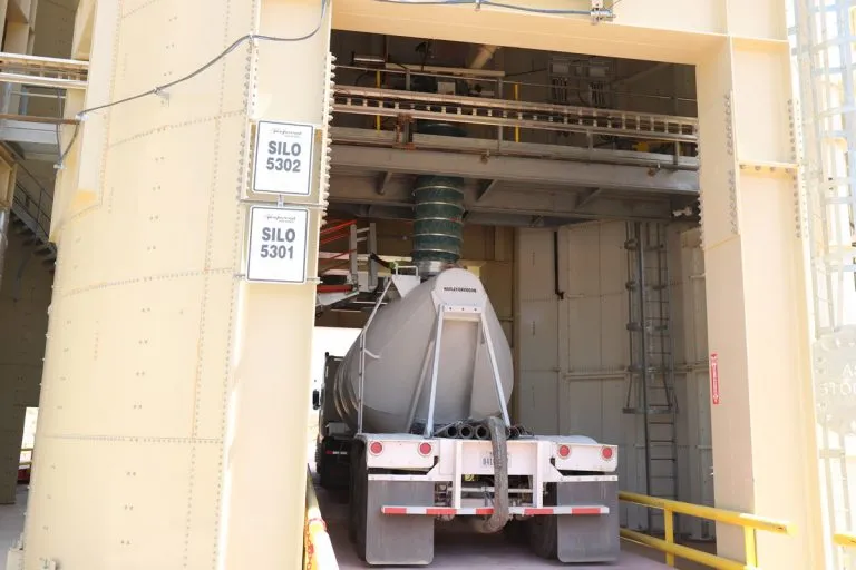 Automated truck loadout bay at frac sand plant