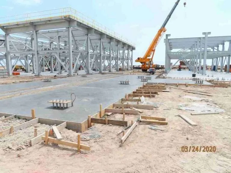 Deep concrete construction and steel erecting for twin reverse air baghouses on a greenfield construction job site
