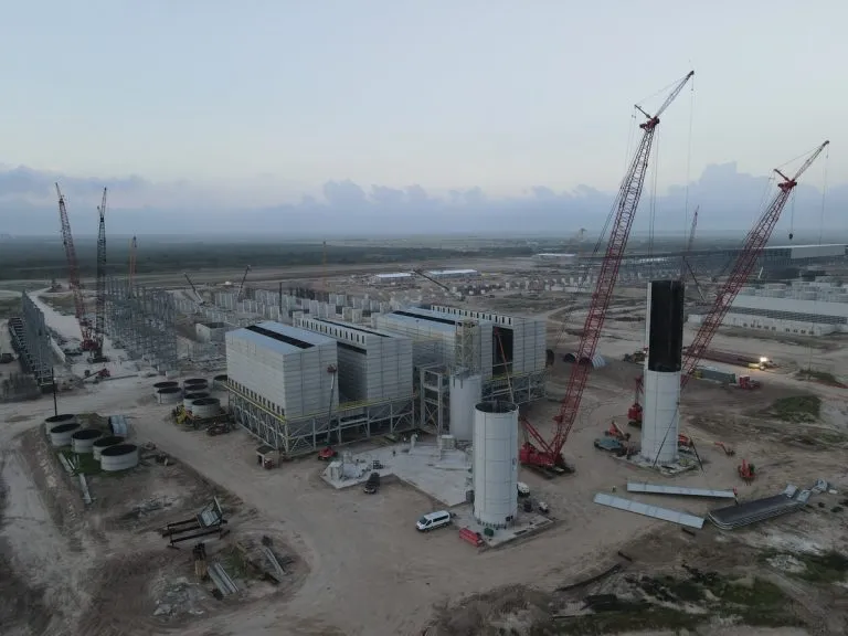 Twin reverse air baghouses and storage silos being constructed for steel production facility